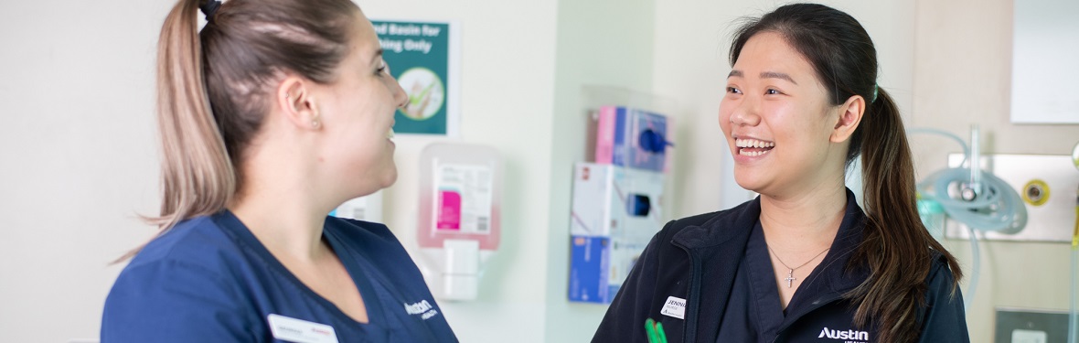 Two smiling Austin Health nurses, one is holding a pen and a clipboard